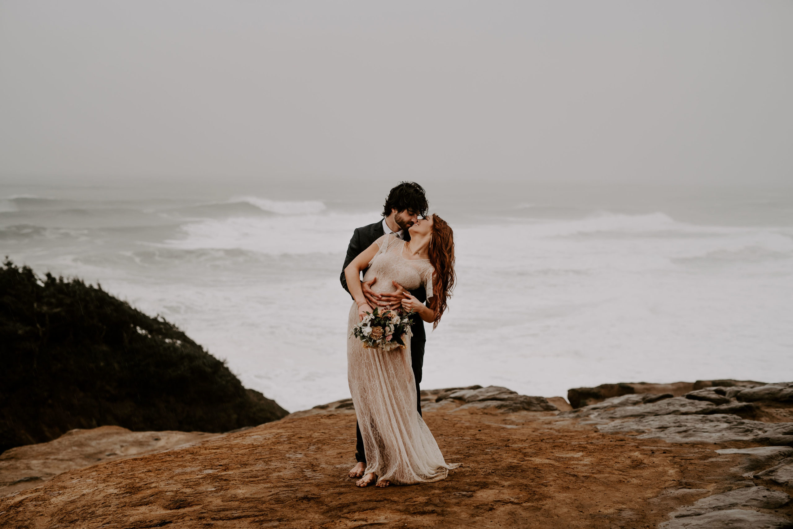 Groom embraces bride from the back during their Oregon Elopement Package Wedding, captured by Off Path Photography