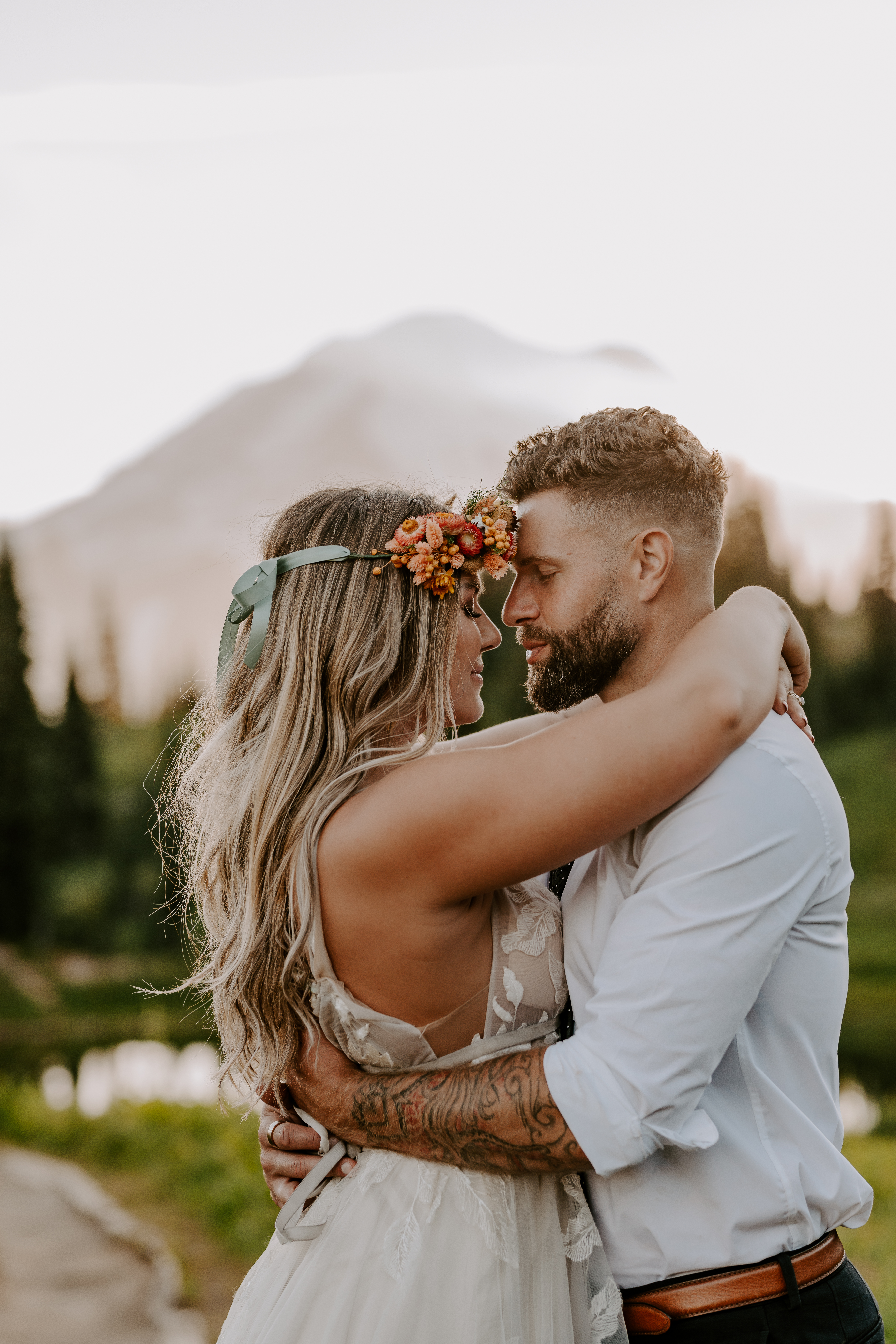 Couple wrapping their arms around each other with their eyes closed during their elopement shoot with Off Path Photography